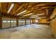 View of the interior of a spacious three car garage with lots of lighting, exposed ceiling beams and a workbench at 4150 Glenn St, Powder Springs, GA 30127