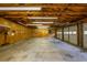 Spacious three car garage with an exposed beam ceiling, lots of lighting, and a wood paneled accent wall at 4150 Glenn St, Powder Springs, GA 30127