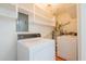 A functional laundry room is equipped with a washer, dryer, and ample storage for convenience at 4150 Glenn St, Powder Springs, GA 30127