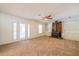Bright living room featuring neutral carpet, a ceiling fan, and a brick fireplace at 4150 Glenn St, Powder Springs, GA 30127