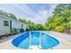 A well-maintained in-ground pool is ready for summer fun, framed by a landscaped yard and mature trees at 4150 Glenn St, Powder Springs, GA 30127