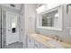 Bathroom featuring double sinks with marble counters, framed mirrors, and tile flooring at 8870 Dornoch Cir, Winston, GA 30187