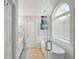 Bright bathroom with modern tub and glass shower, enhanced by natural light and tiled floors at 8870 Dornoch Cir, Winston, GA 30187