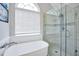 Bright bathroom featuring a modern tub and glass enclosed shower with tile surround at 8870 Dornoch Cir, Winston, GA 30187