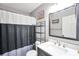 Bathroom featuring a black and white shower curtain and a sink with a black frame mirror at 8870 Dornoch Cir, Winston, GA 30187