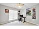 Bedroom with carpet, one window, and ceiling fan; decorated with colorful posters and desk with computer at 8870 Dornoch Cir, Winston, GA 30187