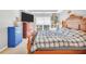 Cozy bedroom with a bed, large window, dresser, and side table with lamp at 8870 Dornoch Cir, Winston, GA 30187