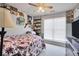 Cozy bedroom with natural light, carpet flooring, and decorative accents on the wall at 8870 Dornoch Cir, Winston, GA 30187