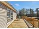 Inviting outdoor deck with wooden railings, offering a cozy space for relaxation and beautiful views at 8870 Dornoch Cir, Winston, GA 30187