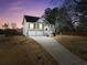 Charming two-story home features a two-car garage and inviting front porch with a well-maintained lawn at 8870 Dornoch Cir, Winston, GA 30187
