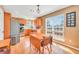 Kitchen featuring stainless steel appliances, wooden cabinets, hardwood floor, dining table set, and large window at 8870 Dornoch Cir, Winston, GA 30187