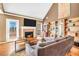 Living room featuring a brick fireplace, hardwood flooring, vaulted ceilings, and a large sectional sofa at 8870 Dornoch Cir, Winston, GA 30187