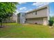 Spacious backyard with large green grass and a two-story home with gray siding at 1087 Berkley Se Dr, Smyrna, GA 30082
