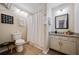 Bathroom featuring white cabinets, granite counters, and a shower-tub combo at 1087 Berkley Se Dr, Smyrna, GA 30082