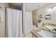 Bathroom featuring dual sinks with granite countertops, neutral tile, and a shower-tub combo at 1087 Berkley Se Dr, Smyrna, GA 30082
