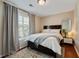 Bedroom with a bed, window, and hardwood floor with gray and beige accents at 1087 Berkley Se Dr, Smyrna, GA 30082