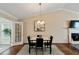Cozy dining room with chandelier, fireplace, and adjacent to an outdoor space at 1087 Berkley Se Dr, Smyrna, GA 30082