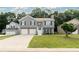 Charming two-story home with gray siding, double garage, and well-maintained front lawn at 1087 Berkley Se Dr, Smyrna, GA 30082