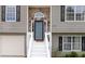 A close up of the home's front entry showcasing stone accents and crisp white stairs at 1087 Berkley Se Dr, Smyrna, GA 30082