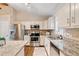 Updated kitchen with stainless steel appliances, granite countertops and an island at 1087 Berkley Se Dr, Smyrna, GA 30082