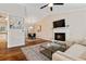 Open living room featuring a brick fireplace and seamless flow to the dining area at 1087 Berkley Se Dr, Smyrna, GA 30082