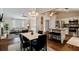 Bright living room flowing into the kitchen with wood floors, neutral walls, modern lighting and stainless steel appliances at 1087 Berkley Se Dr, Smyrna, GA 30082
