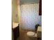 Bathroom with floral shower curtain at 2463 Stone Rd, East Point, GA 30344