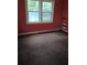 Bedroom with red walls and bright window at 2463 Stone Rd, East Point, GA 30344