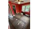 Red bedroom featuring two bright windows and assorted trash on the carpeted floor at 2463 Stone Rd, East Point, GA 30344