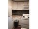 Kitchen featuring white appliances, countertops, cabinets, and backsplash at 2463 Stone Rd, East Point, GA 30344