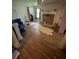 Open-concept living room with wood floors, a fireplace, and bright natural light at 2463 Stone Rd, East Point, GA 30344