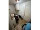 Small cluttered room with cabinets, a door to the exterior, and laminate flooring at 2463 Stone Rd, East Point, GA 30344