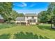 Spacious backyard with deck, lush green lawn, and view of the rear of the house at 285 Sw Martin Sw Way, Marietta, GA 30064
