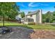 Landscaped backyard with patio, lush green lawn, and the rear of the house at 285 Sw Martin Sw Way, Marietta, GA 30064