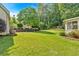 Lush backyard with mature trees, manicured lawn, and view of the rear of the house at 285 Sw Martin Sw Way, Marietta, GA 30064