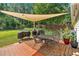 Backyard patio with shade, dining set, and view of the fenced-in yard with playground at 285 Sw Martin Sw Way, Marietta, GA 30064