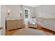 A cozy Bedroom offers a comfortable chair, crib, dresser, and a charming round rug at 285 Sw Martin Sw Way, Marietta, GA 30064