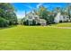 Spacious front lawn with a charming home, offering a two-car garage and a peaceful atmosphere, enveloped by lush greenery at 285 Sw Martin Sw Way, Marietta, GA 30064