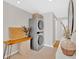 A modern laundry room showcases a stacked washer and dryer, complemented by a stylish side table at 285 Sw Martin Sw Way, Marietta, GA 30064