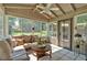 Inviting sunroom with tiled floors, neutral furniture, and many windows with backyard view at 285 Sw Martin Sw Way, Marietta, GA 30064
