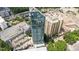An aerial view showcasing a sleek modern building with high-rise apartments and a rooftop pool amenity at 3338 Peachtree Rd # 2005, Atlanta, GA 30326