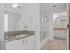 Bright and modern bathroom with marble countertops and a glass-enclosed shower at 3338 Peachtree Rd # 2005, Atlanta, GA 30326