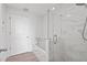 Bright bathroom featuring a bathtub, a glass-enclosed shower and marble walls at 3338 Peachtree Rd # 2005, Atlanta, GA 30326
