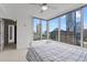 Bedroom with cityscape views from large windows, ceiling fan, and bright white carpet at 3338 Peachtree Rd # 2005, Atlanta, GA 30326