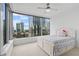 Bedroom with cityscape views, white walls, ceiling fan, and a cozy bed at 3338 Peachtree Rd # 2005, Atlanta, GA 30326