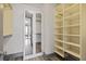 Walk-in closet with adjustable shelving and mirrored doors for ample storage solutions at 3338 Peachtree Rd # 2005, Atlanta, GA 30326