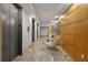 Hallway featuring tile floors, modern elevators, wood paneling, and a seating area at 3338 Peachtree Rd # 2005, Atlanta, GA 30326