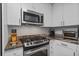 Well-equipped kitchen featuring stainless steel appliances, ample counter space, and stylish white cabinetry at 3338 Peachtree Rd # 2005, Atlanta, GA 30326