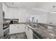 A modern kitchen with granite countertops, stainless steel appliances, and a seamless flow to the living area at 3338 Peachtree Rd # 2005, Atlanta, GA 30326