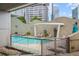 Beautiful pool area with comfortable lounge chairs, lush landscaping, and city views at 3338 Peachtree Rd # 2005, Atlanta, GA 30326
